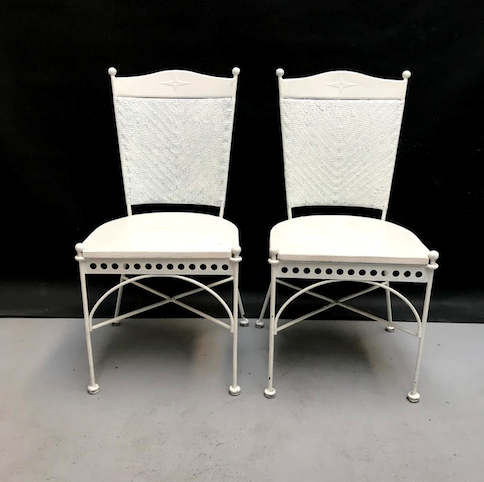 Picture of two white iron, wicker and wood chairs