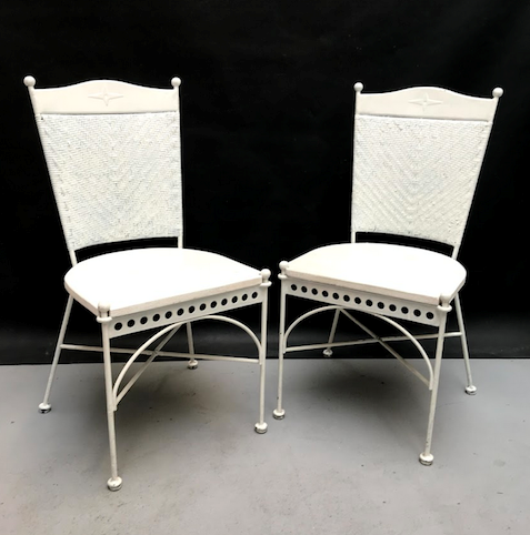 Picture of two white iron, wicker and wood chairs