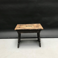 Picture of short primitive stool in scraped off dark brown wood